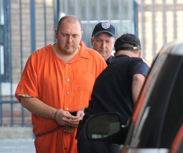 michael carneal is escorted by a guard from the u.s. district courthouse