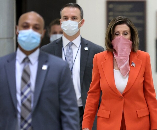 nancy pelosi wears a scarf over her face