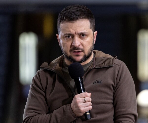 volodymyr zelenskyy speaks into a microphone