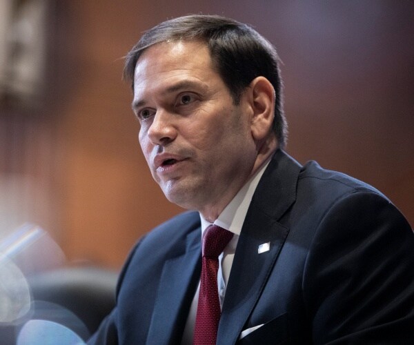 marco rubio speaks into a microphone