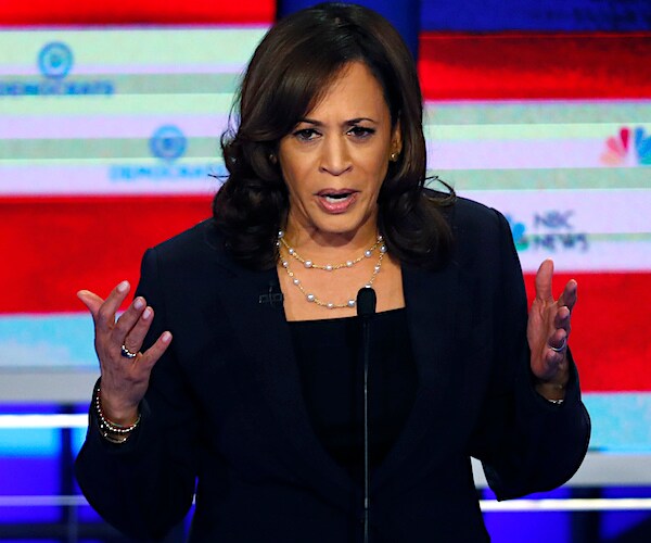 kamala harris exults with both hands during a democratic presidential primary debate