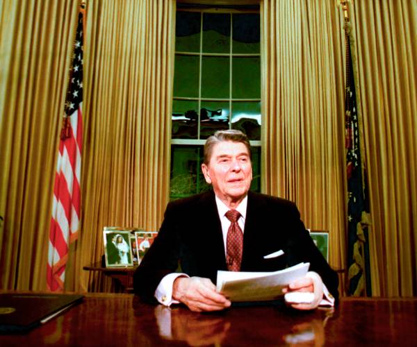 reagan sitting in the oval office