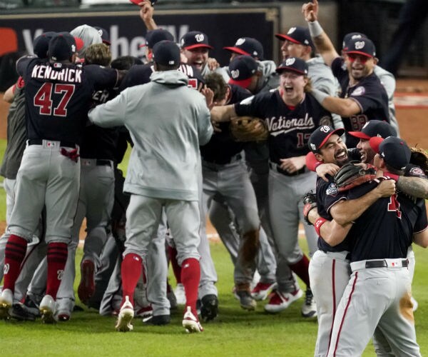 washington nationals players celebrate on the baseball field after game 7 of the world series