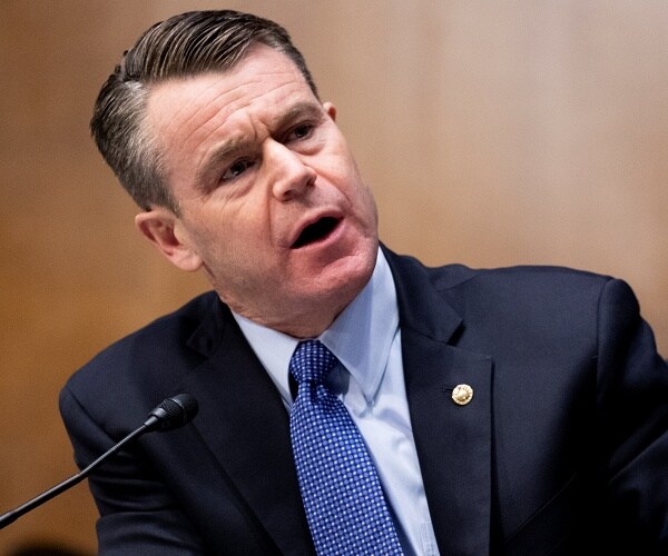 todd young speaks into mic