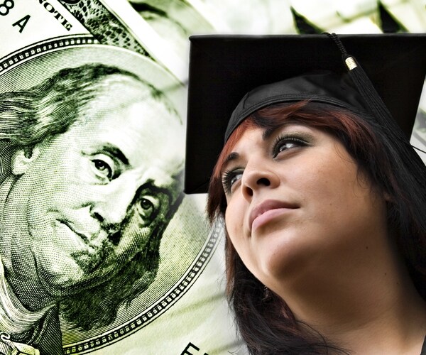 A closeup of a female graduate in her cap and gown in front of a $100 bill money background. 