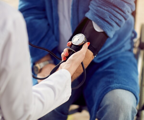 checking a patient's blood pressure