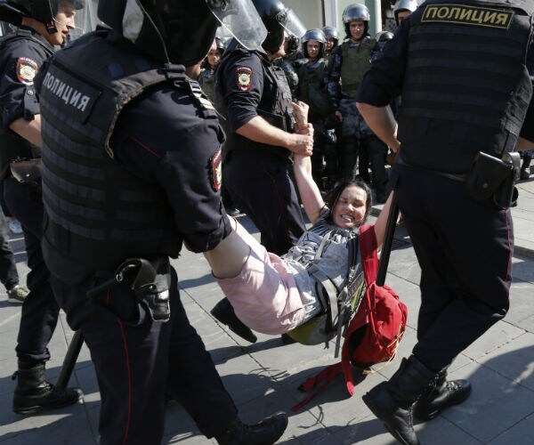 Police drag a female protester
