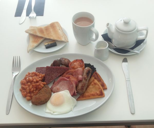 breakfast on a plate with coffee and toast
