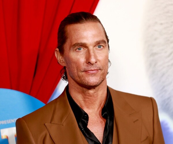 matthew mcconaughey stands on red carpet