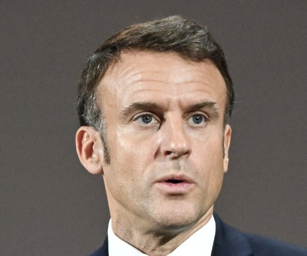 President Emmanuel Macron looks on