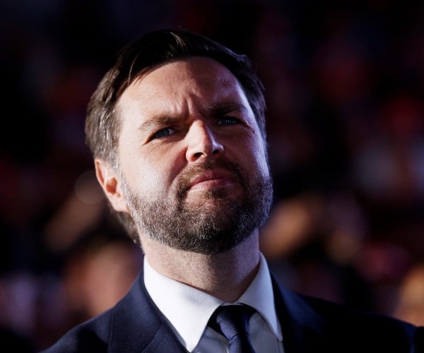 a man wearing a suit looks on