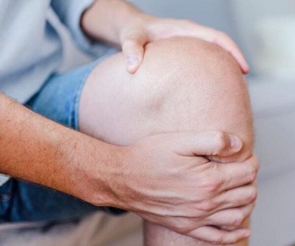 person holding knee