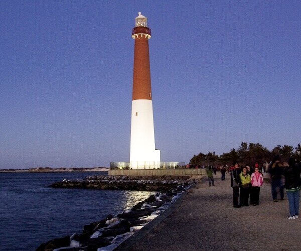 the lighthouse sits on the beach