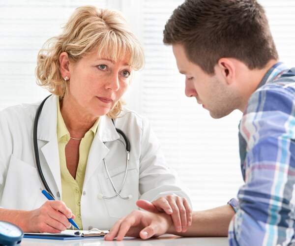 a doctor speaks with a patient