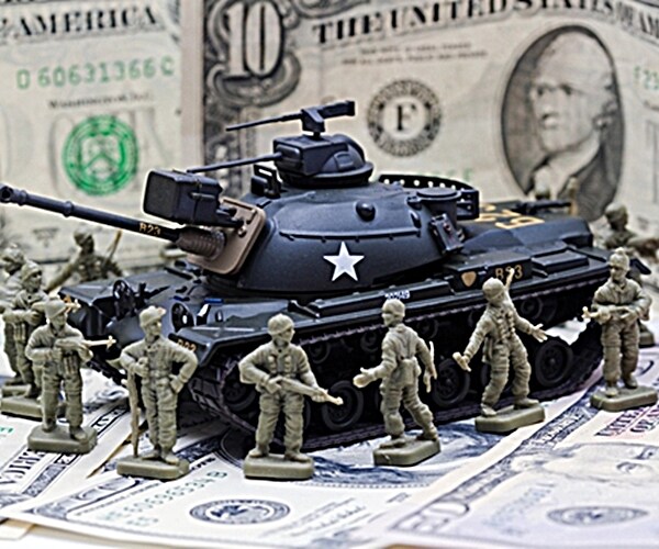 toy soldiers and tank atop a bed of $100 bills