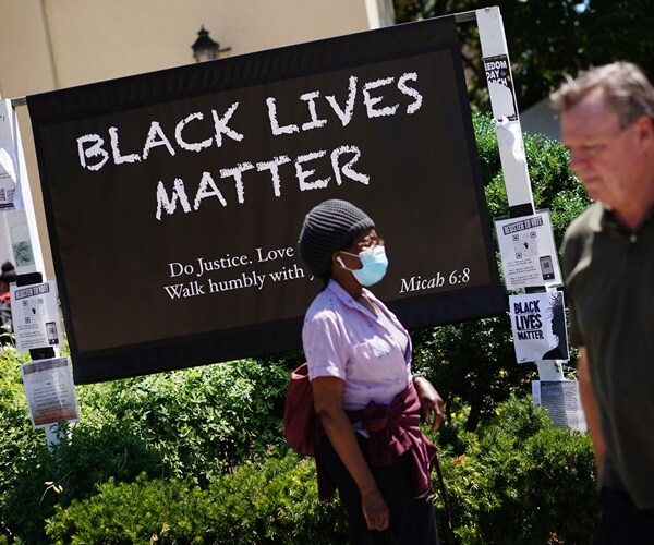 a black lives matter sign is outside a church