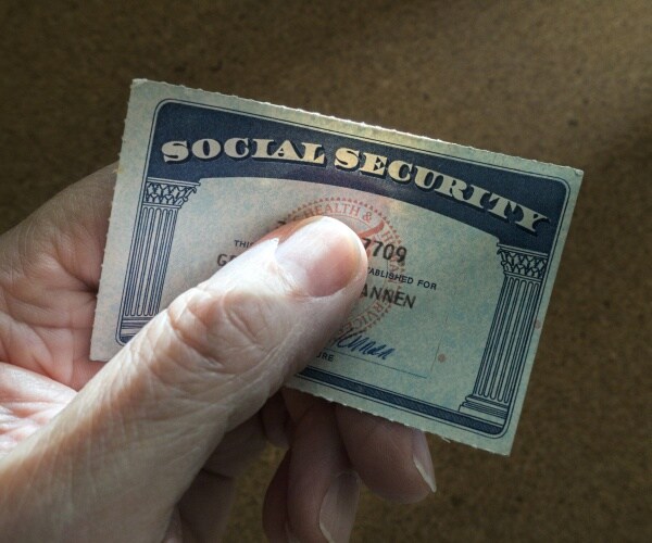 man holding social security card