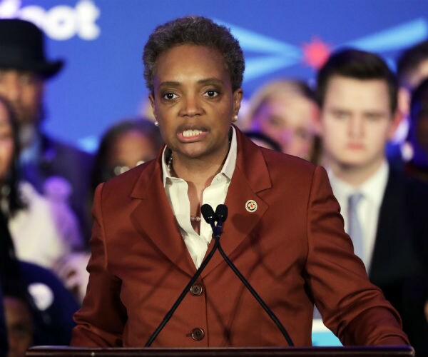 lori lightfoot speaks in a creme blouse and burgundy jacket