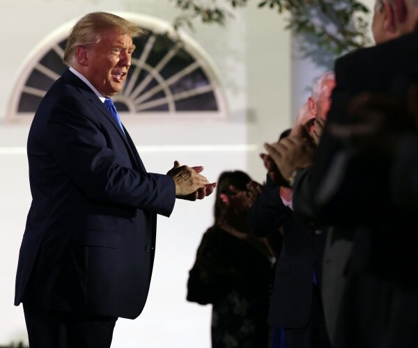 President Donald Trump greets guests