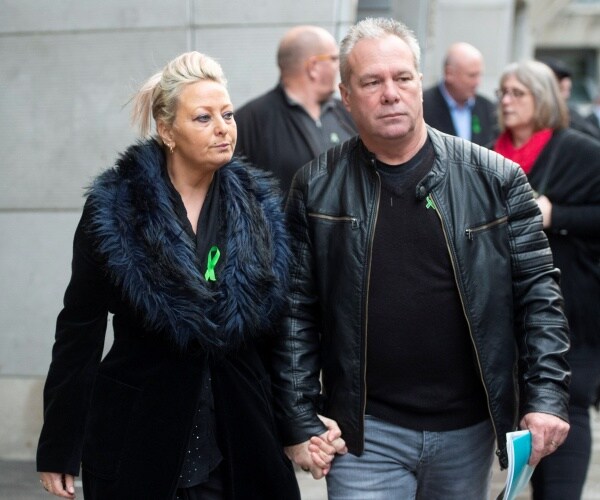 charlotte charles in a black furry coat and bruce charles in a black shirt jeans and black leather jacket