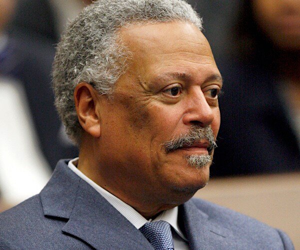 judge emmet sullivan looks forward with a smirk