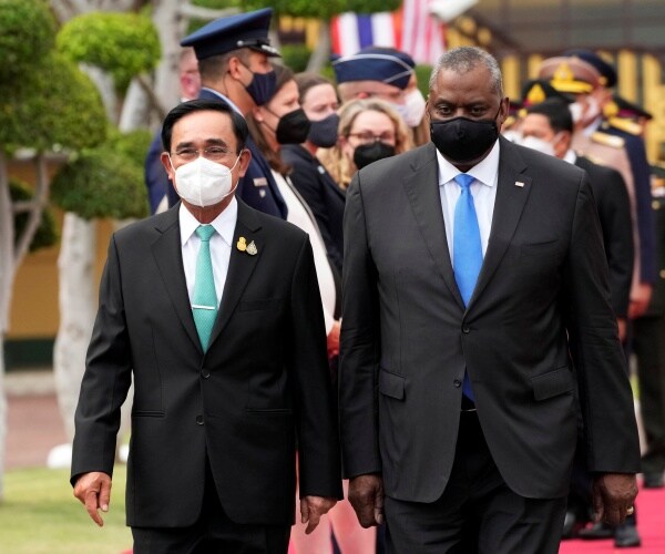 lloyd austin walks alongside prayuth chan-ocha