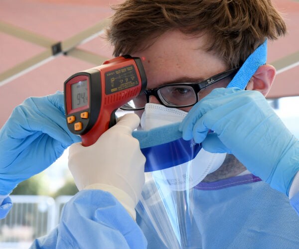 a person is shown getting their temperature taken