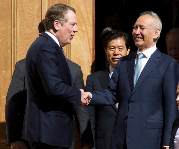 standing on the top of steps. trade rep. lighthizer shakes hands with the chinese trade representative