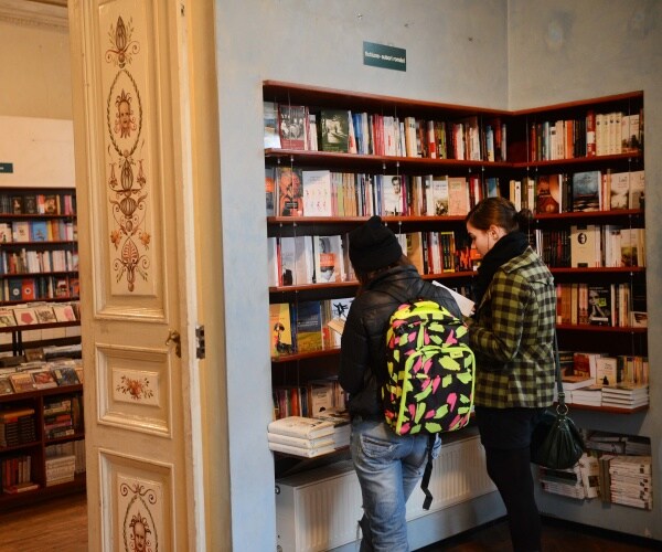 two women look through books at a store