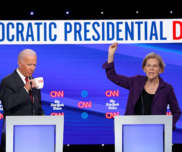 joe biden sips from a mug while elizabeth warren exults during a democratic presidential primary debate
