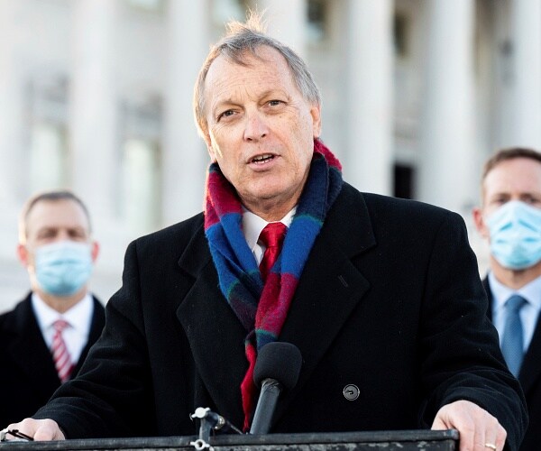 andy biggs speaks from behind podium