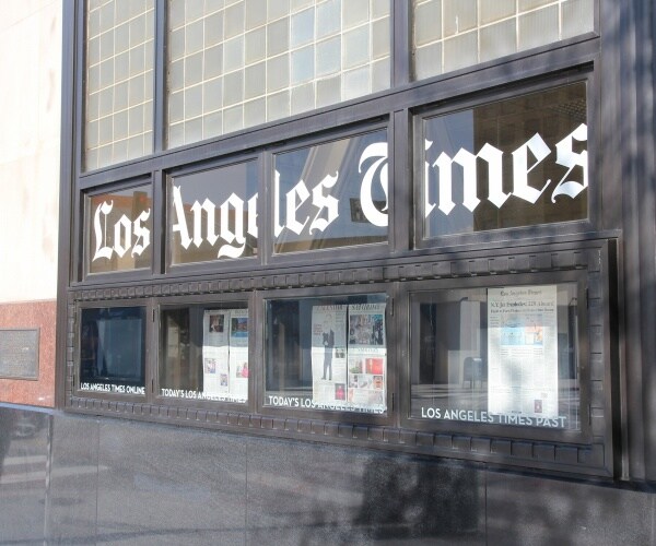 Los angeles times office in LA with newspapers on the inside of the window