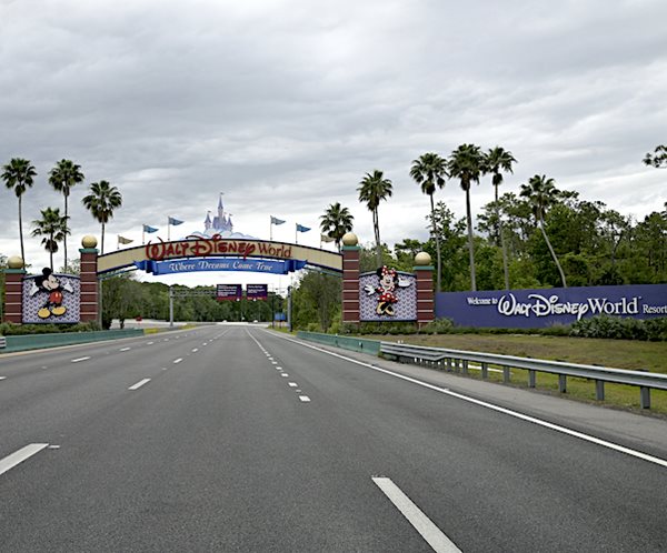 An empty highway is viewed leading to at an entrance of the Walt Disney World Resort earlier this April