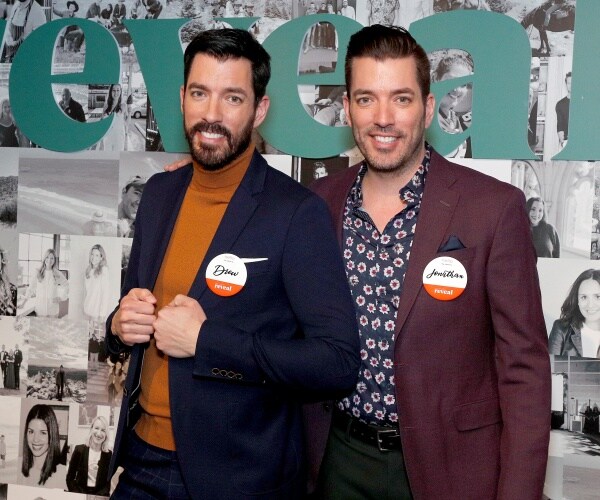 jonathan scott in a patterned shirt and maroon blazer with drew in a yellow top and blue blazer