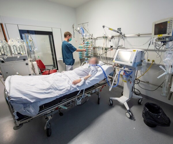 a patient lies in a hospital room in germany