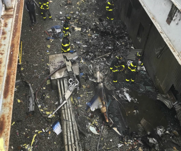the shattered remains of the helicopter atop the building where it crashed