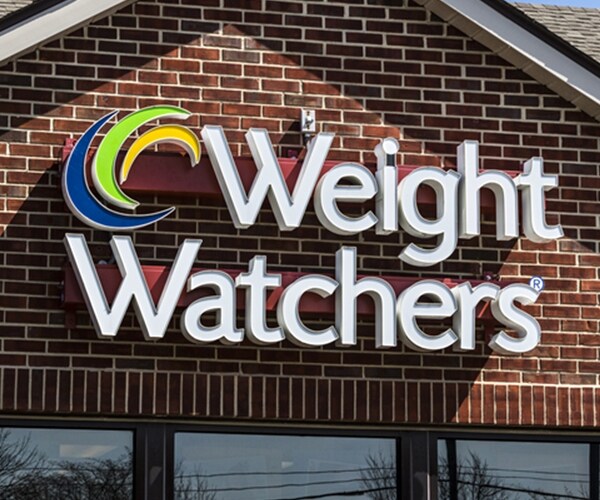 Weight Watchers sign logo on front of red brick building