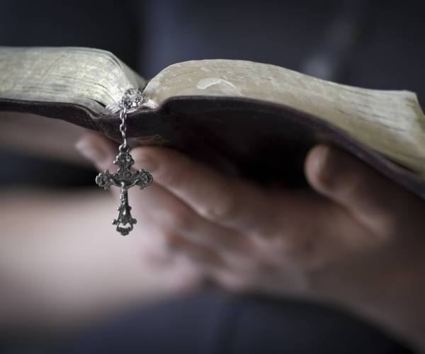 a hand holding open a bible