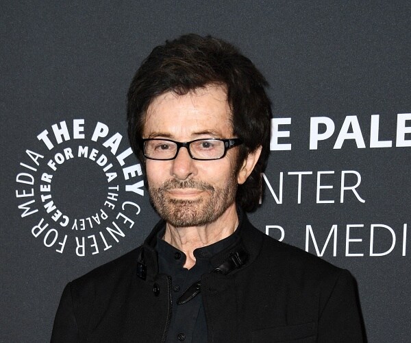 george chakiris stands on red carpet