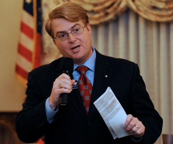 marc scaringi speaks into microphone