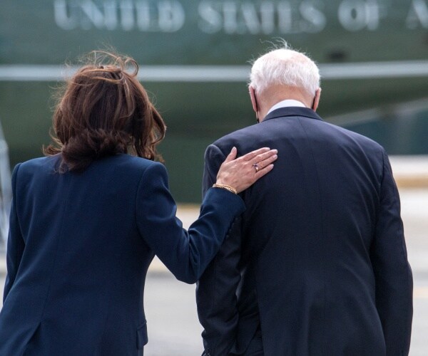 kamala harris pats joe biden on the back