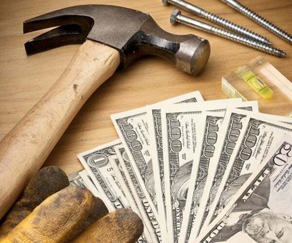  still-life with building tools, money hammer, level, screws and work gloves 