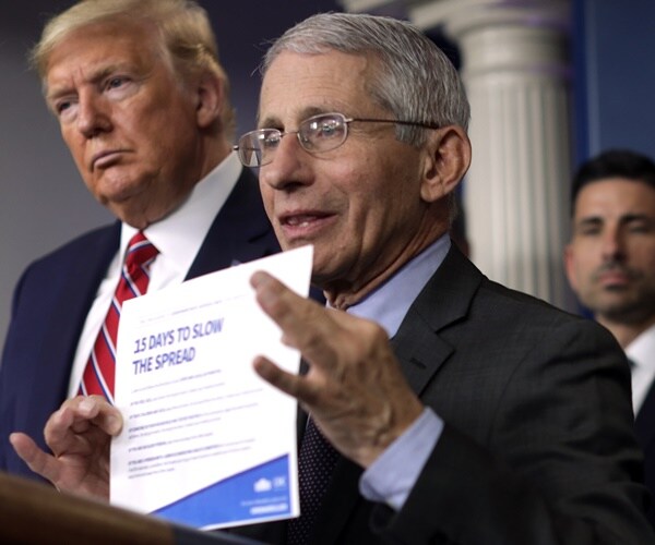 dr. fauci stands at the podium during a coronavirus briefing.