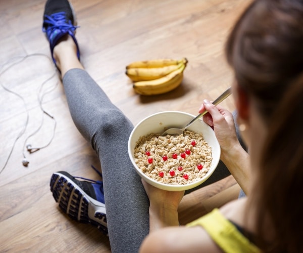 woman eating bowl of oatmeal