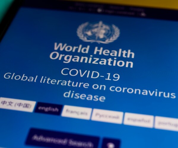 tablet screen on World Health Organization COVID-19 information web page
