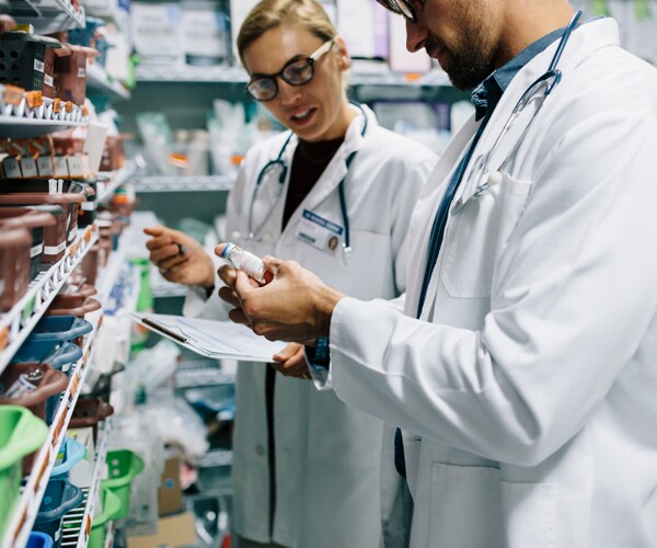 pharmacists looking at drugs