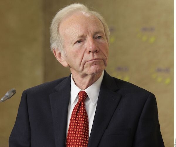 joe lieberman looks to his left while listening during a news conference