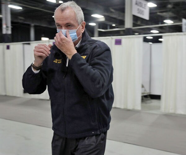phil murphy is shown wearing a blue mask