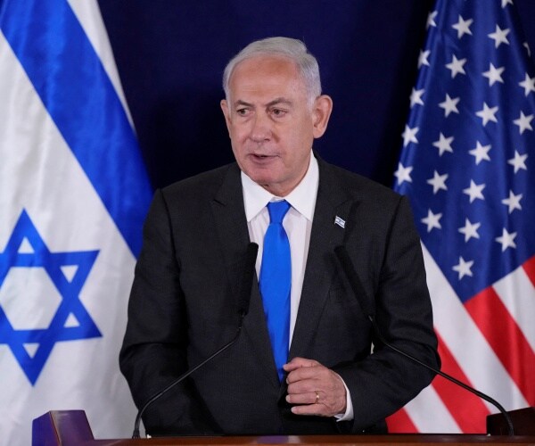 a man wearing a suit looks on