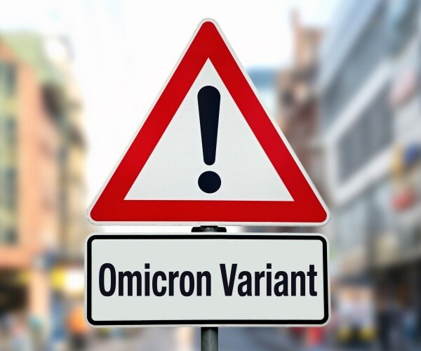 warning street sign says "Omicron Variant"